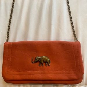 Orange cross body with elephant pendent